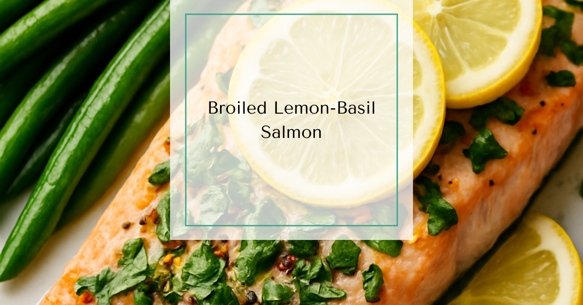 A broiled salmon fillet garnished with fresh basil and lemon slices.