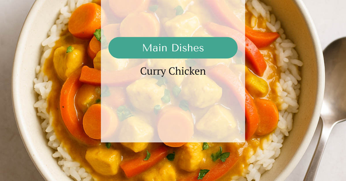 Curry chicken in a golden coconut-tomato sauce with carrots, bell pepper, and cilantro, served in a wide bowl over rice.