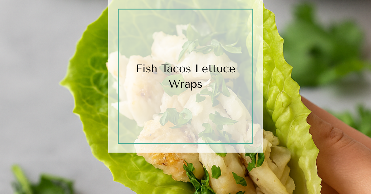 A lettuce-wrapped fish taco filled with flaky white fish and fresh herbs, held in hand over a table.