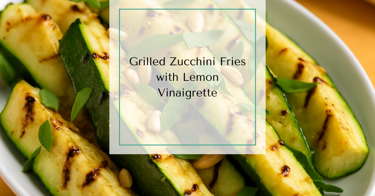 A white dish filled with grilled zucchini spears, garnished with fresh basil and toasted pine nuts.