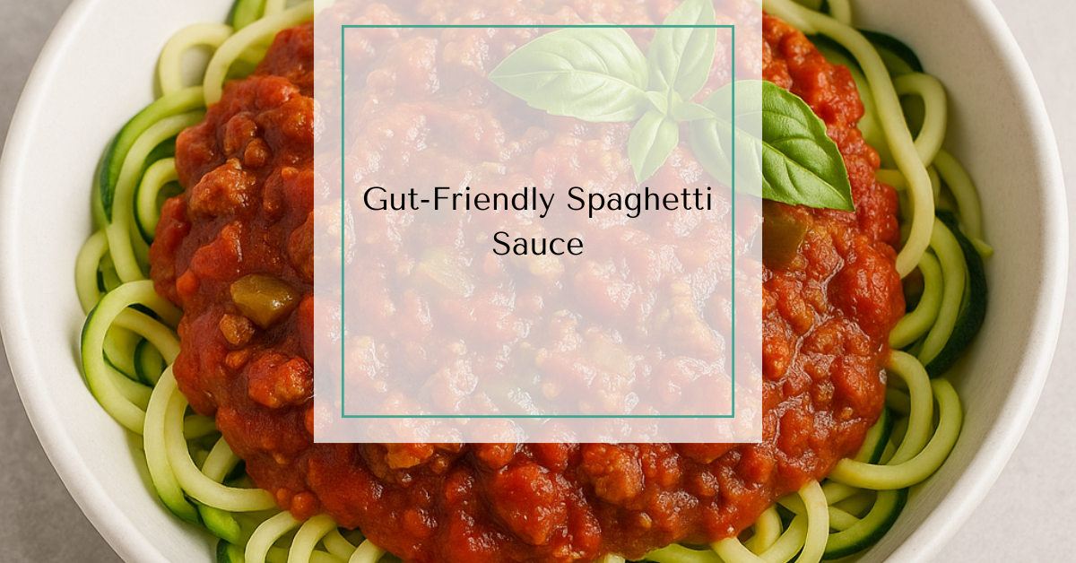 A bowl of rich homemade spaghetti sauce with ground beef, green peppers, and fresh basil, served over spiralized zucchini.