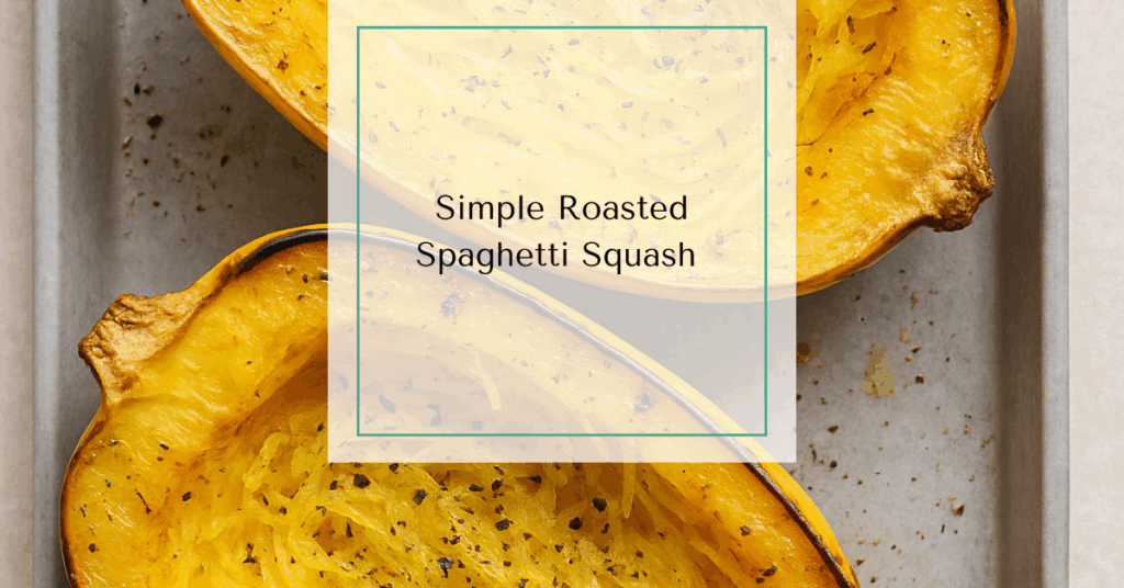 Halved and roasted spaghetti squash with golden, forked strands seasoned with olive oil and spices on a baking sheet.