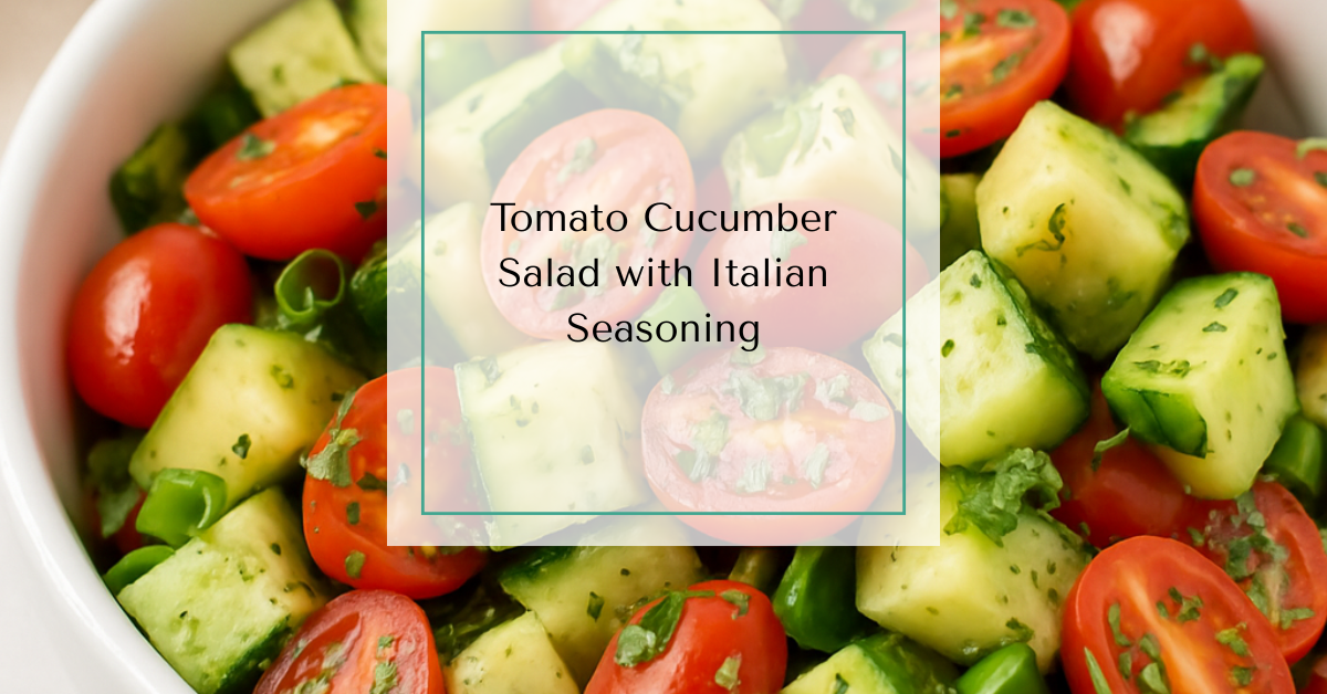 A bowl of vibrant tomato cucumber salad with fresh herbs and oil glistening on the vegetables.