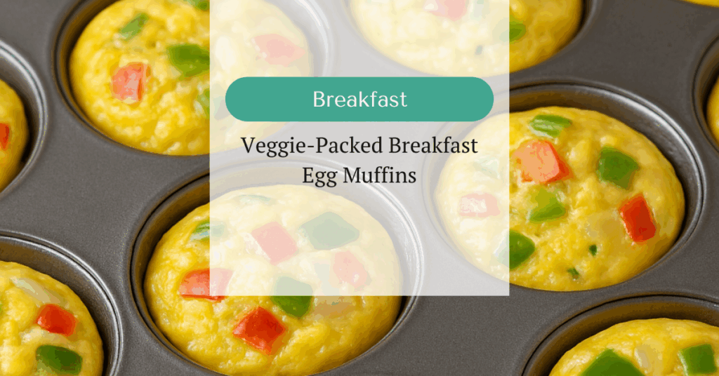 Muffin tin filled with baked egg muffins containing bell peppers and onions.