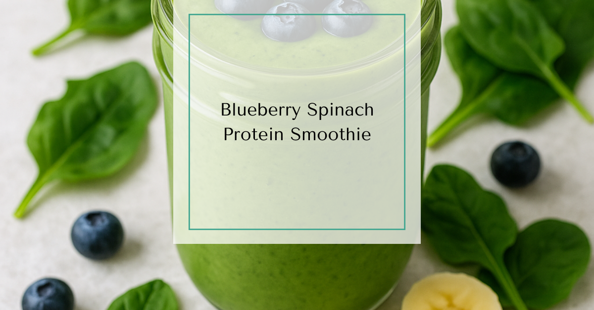Green blueberry protein smoothie in a glass jar, topped with fresh blueberries and surrounded by spinach leaves and banana slices.