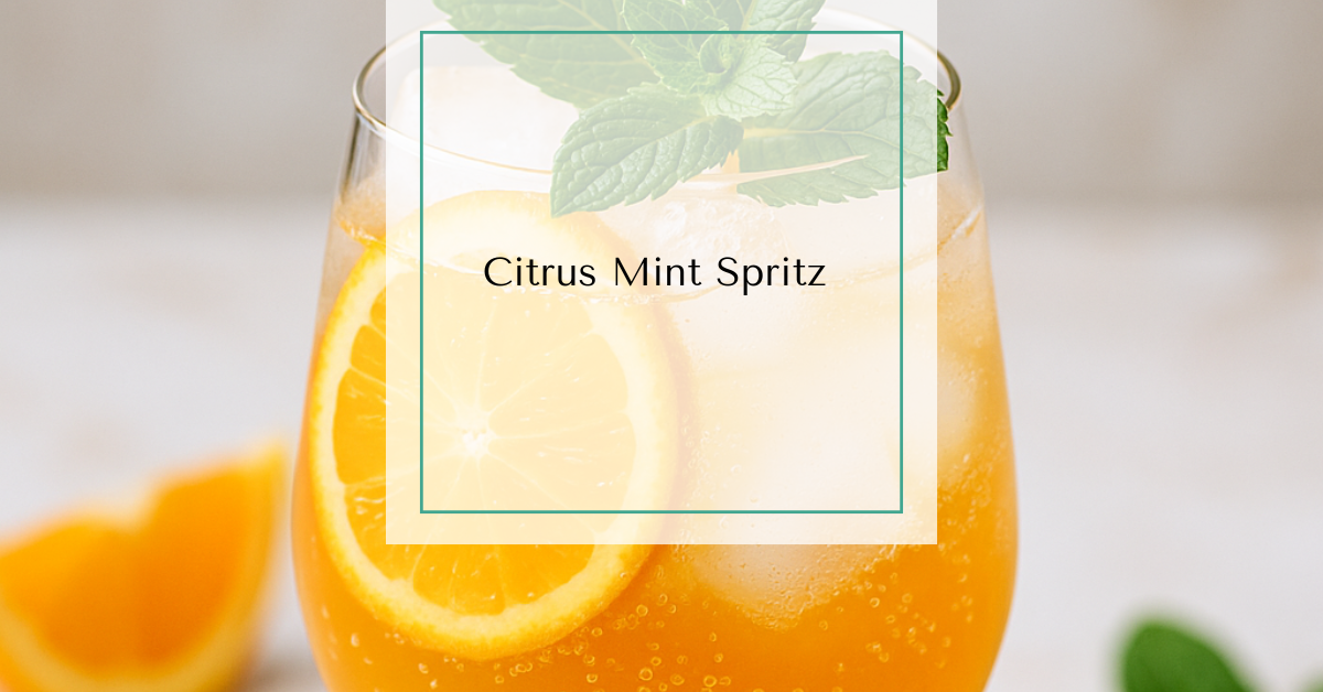 A sparkling citrus spritz mocktail in a stemmed glass with ice cubes, orange slices, fresh mint, and bubbles rising to the top.