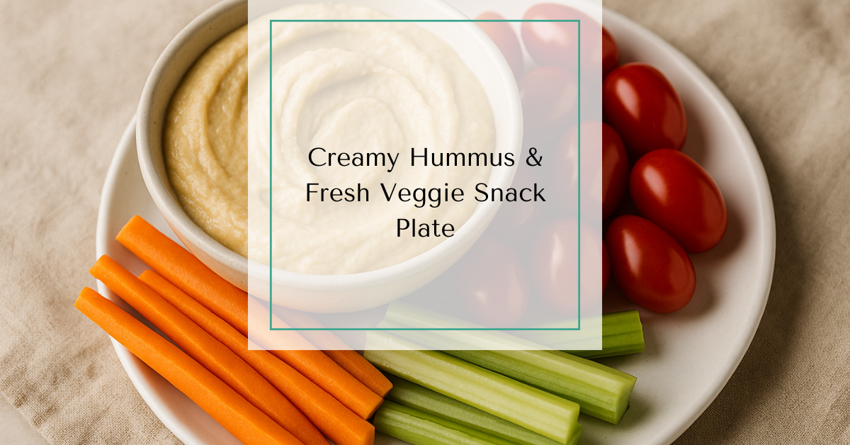 A ceramic bowl filled with creamy hummus, surrounded by an assortment of fresh vegetables including grape tomatoes and carrot sticks.