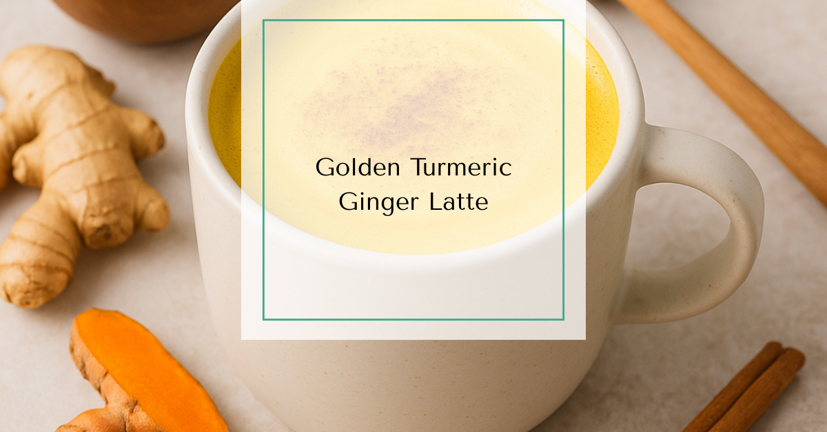 A warm mug of golden turmeric ginger latte with frothy almond milk, topped with a sprinkle of cinnamon and surrounded by fresh turmeric, ginger, and a honey dipper.