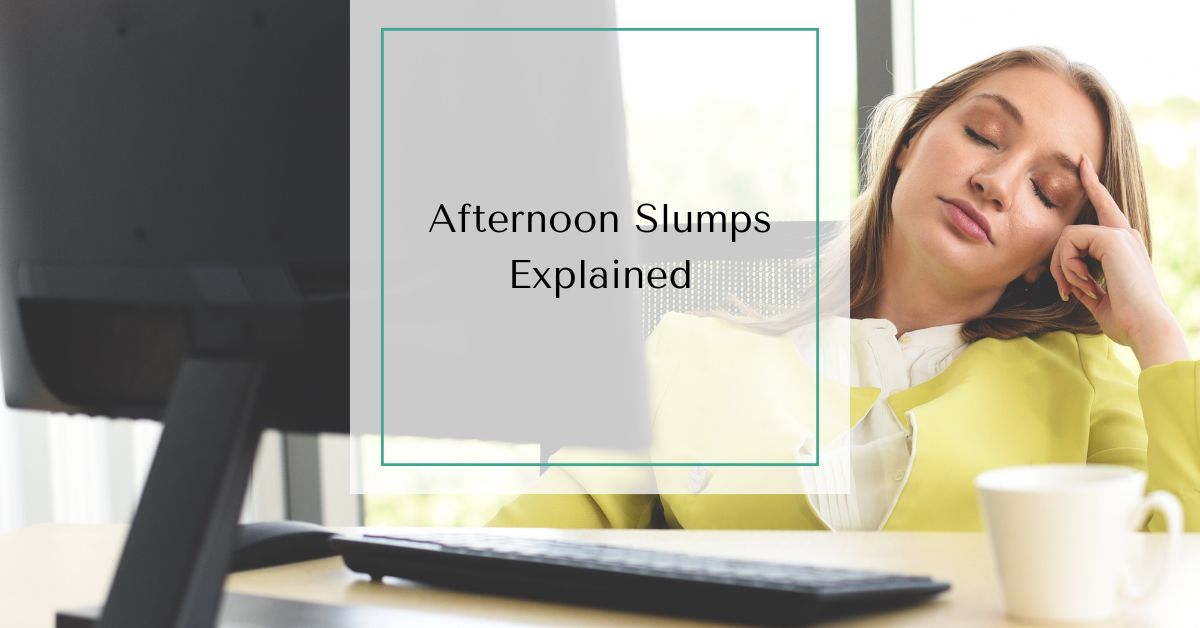 Woman experiencing afternoon slump causes at 3pm with low energy and brain fog while working at a computer