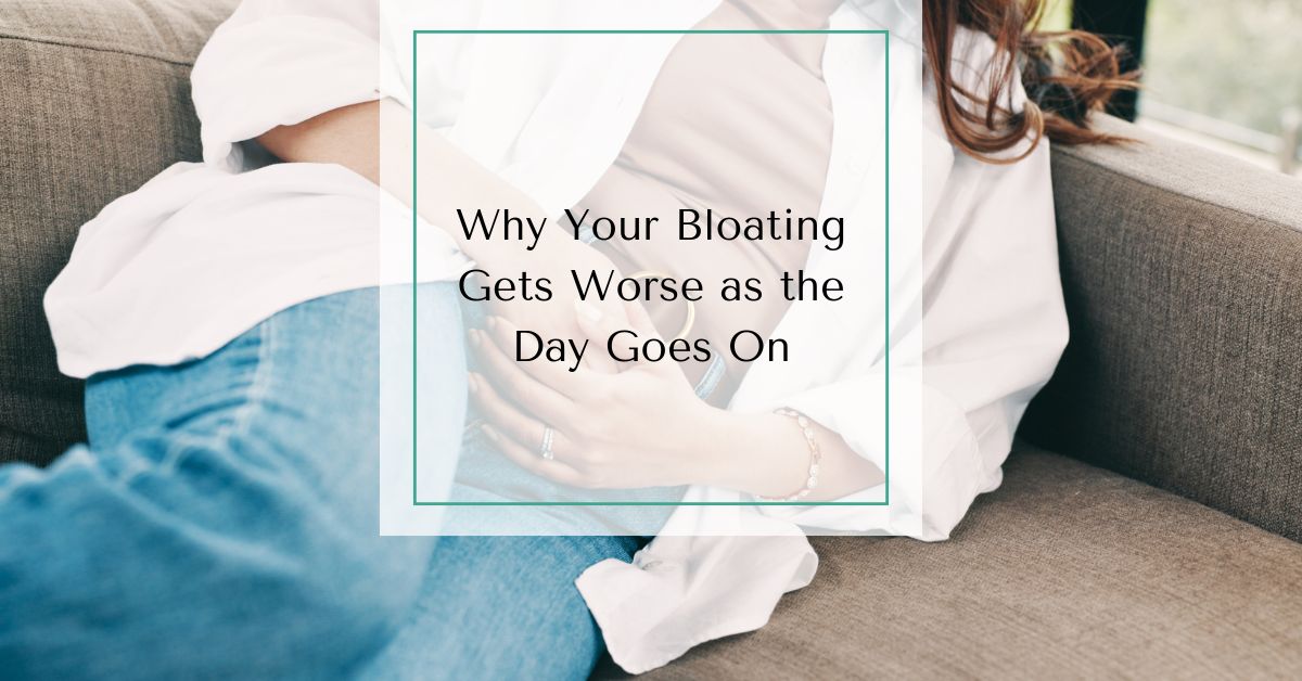 Woman reclining on a couch holding her stomach, with text overlay that reads “Why Your Bloating Gets Worse as the Day Goes On.”