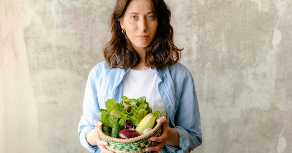 Woman in midlife holding a bowl of healthy food while looking frustrated