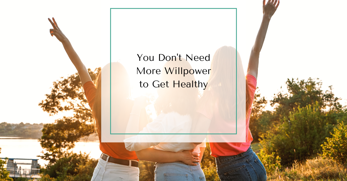 Three women standing together with arms raised at sunset with text overlay reading “You Don’t Need More Willpower to Get Healthy.”
